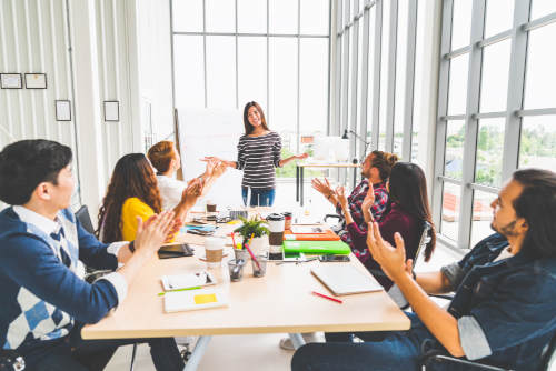 a woman successfully leading a meeting.